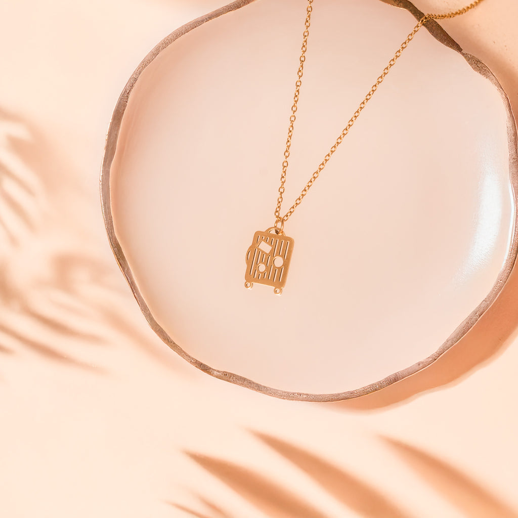 luggage gold necklace