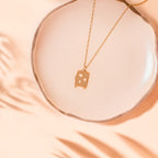 luggage gold necklace