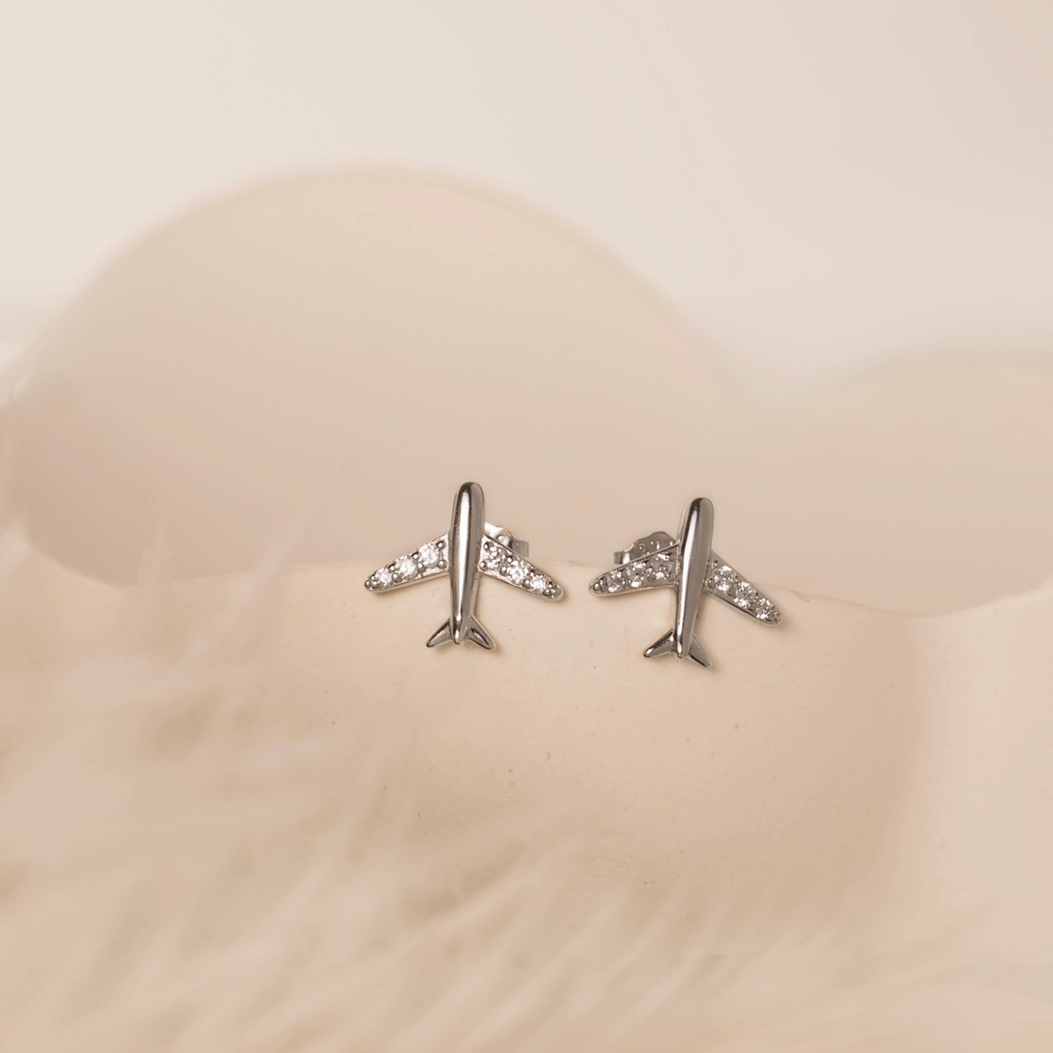 silver plane stud earrings