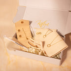 Jewelry set with necklaces, bracelet and earrings in a gift box on a marble surface.